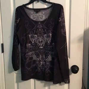 sheer top with tiger faces and other designs.